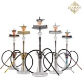 A collection of four distinct hookahs, showcasing various designs and colors, arranged aesthetically